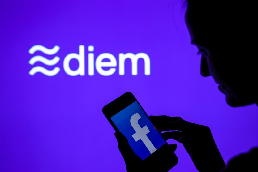 Silhouette of a woman looking at the Facebook logo on smartphone in front of Diem name and logo