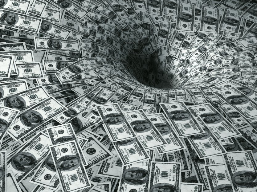 Dollar bills swirling into a void, symbolising money losses