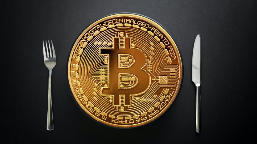 Bitcoin flanked by a knife and fork