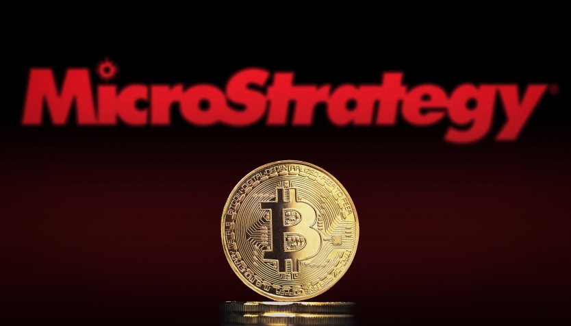 A bitcoin in front of the MicroStrategy logo