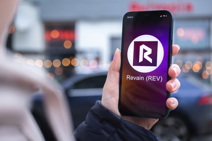 Revain logo displayed on a smartphone screen