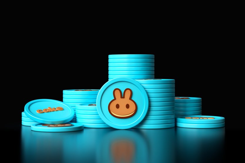 Stacks of blue PancakeSwap tokens against black background – Photo: Shutterstock