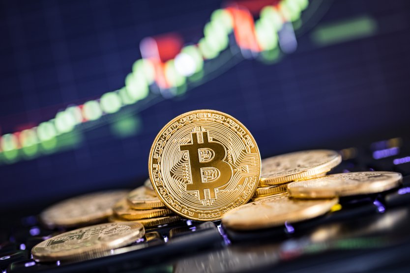 A Bitcoin token set against a falling graph