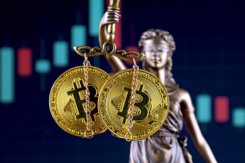 The Greek goddess of justice holds up two bitcoins on a scale